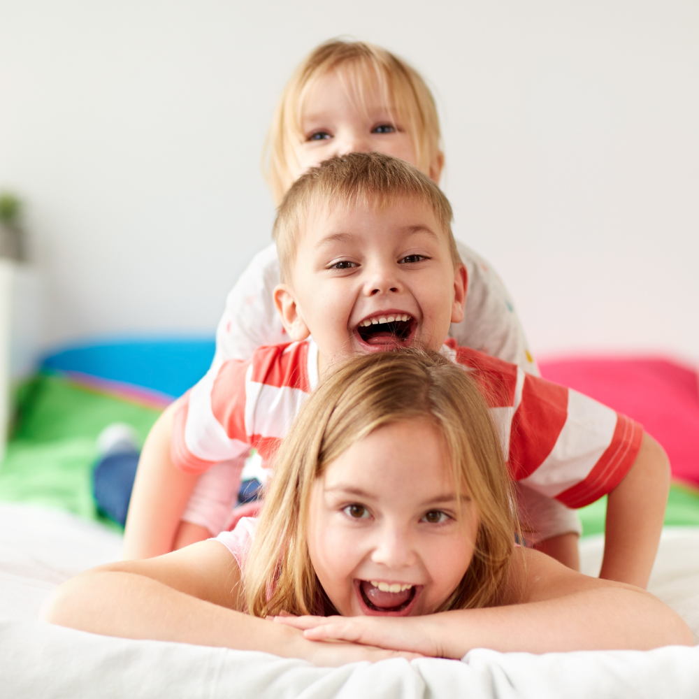 picture shows three kids smiling to emphasise the idea of positive self eteem in kids 