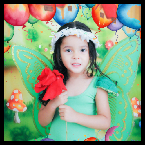 best themes for birthday parties in 2025 and beyond include the enchanted forest birthday party. little girl is wearing a green enchanted fairy costume and is surrounded by balloons.